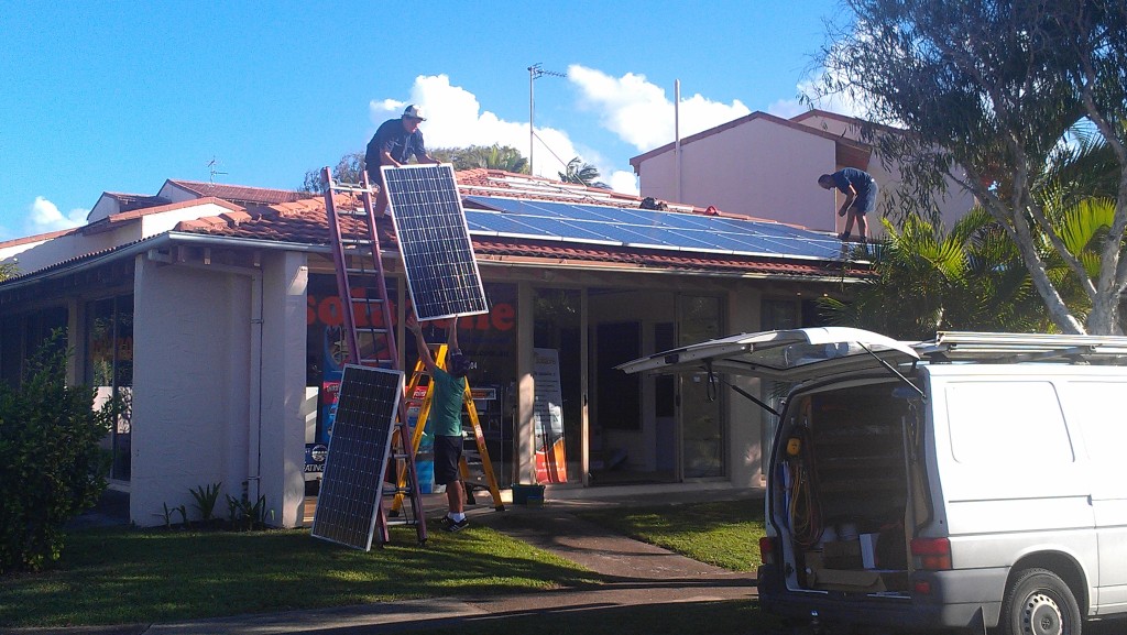 Solazone installing solar panels on a shop
